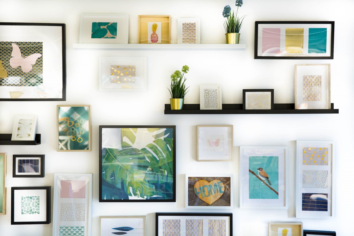 A wall hung with many different picture frames