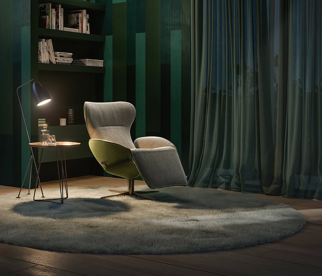 A JORI Daydreamer armchair lit by a floor lamp